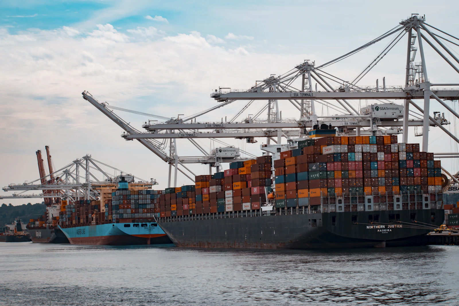 Container yard showing ISO shipping containers stacked at port